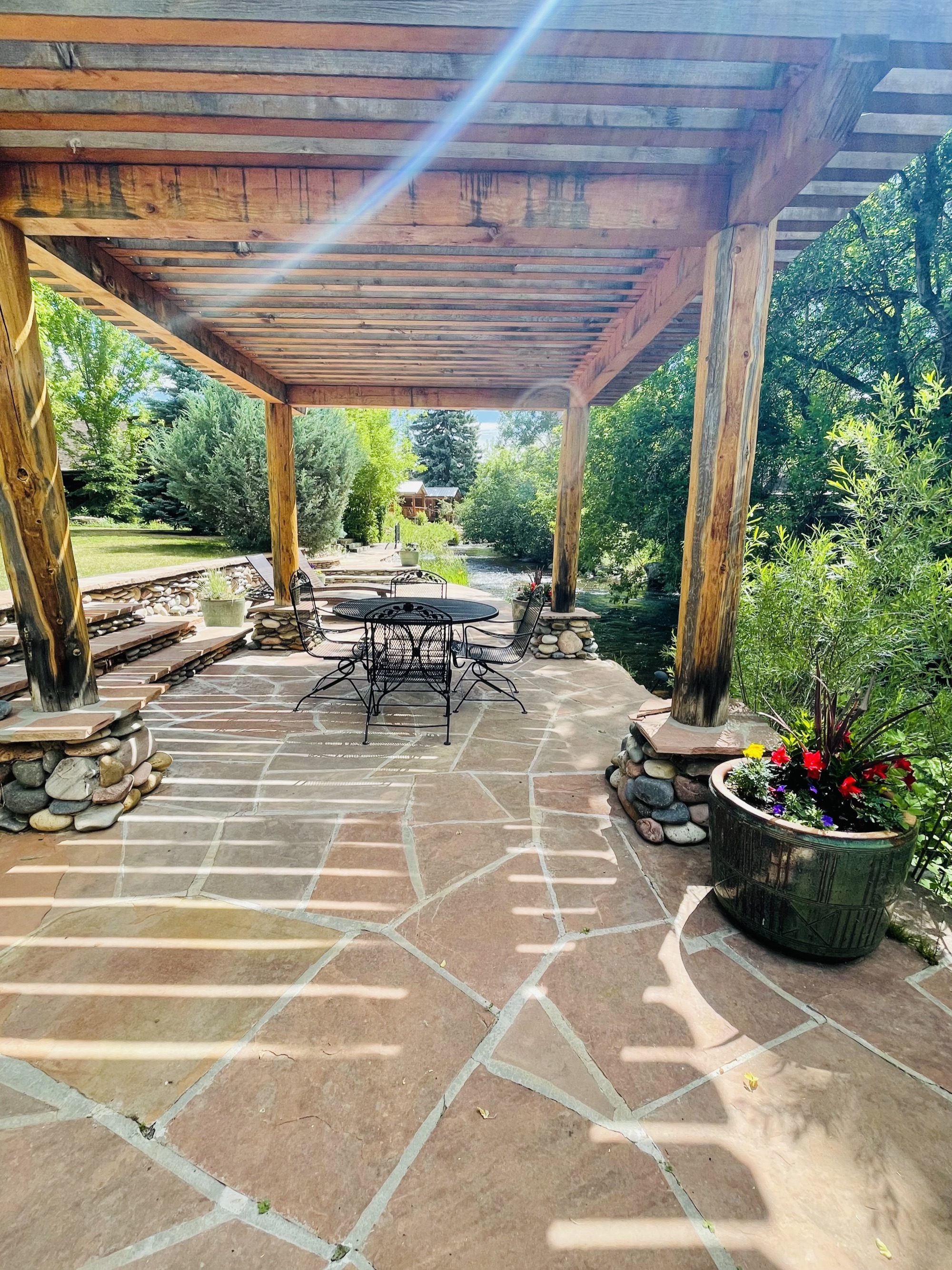 Stone patio under pergola